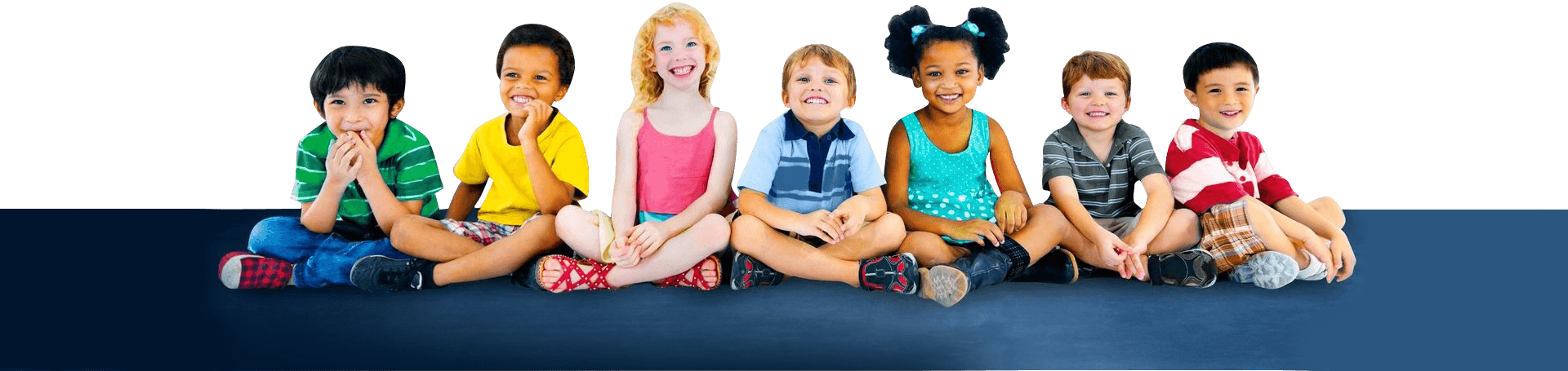 A group of children sitting on the ground.