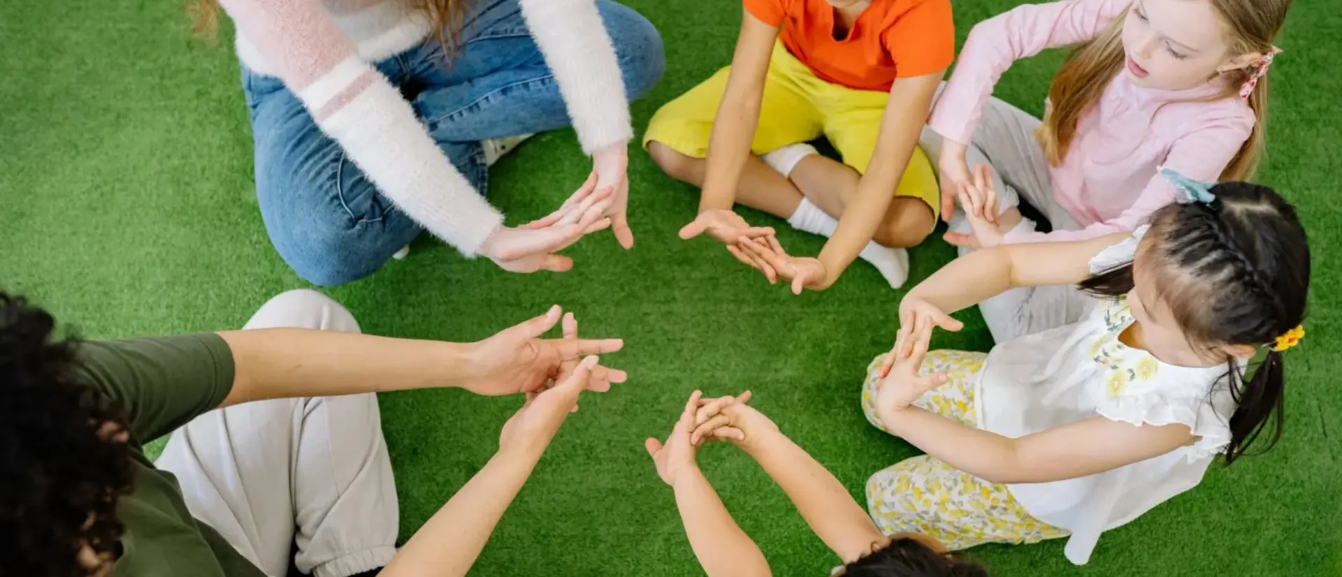 A group of people sitting in the middle of a circle.